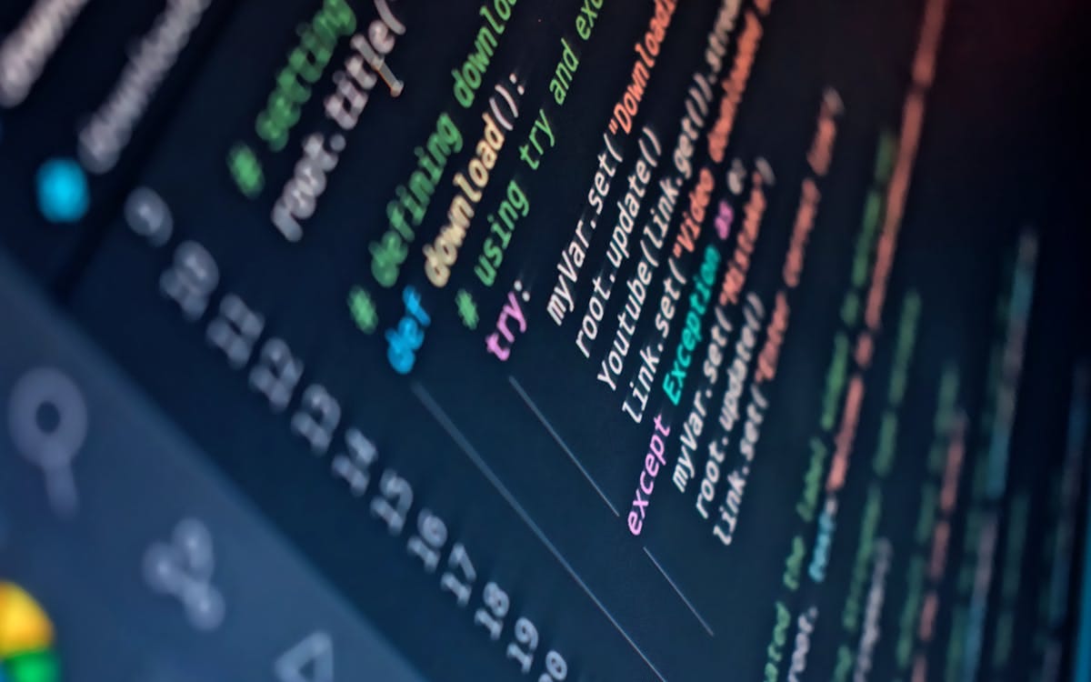 Close-up of colour syntax-highlighted source code on a dark screen with line numbers — the intangible asset that is the real value of a software business