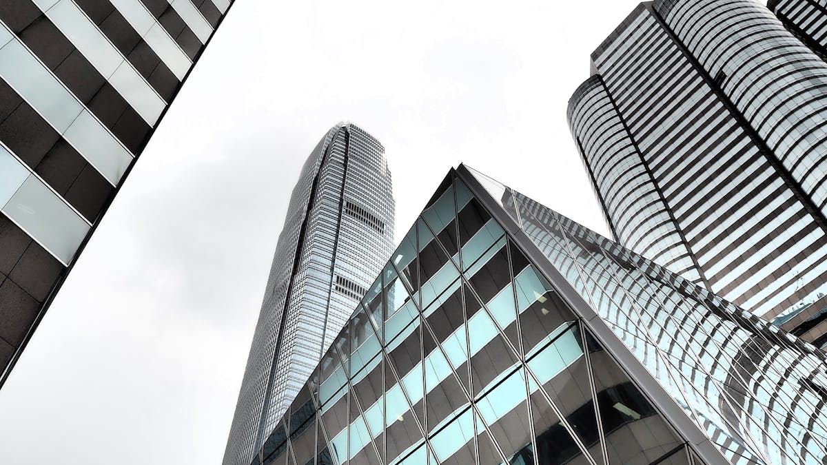 Modern Hong Kong office tower facade — the kind of corporate address re-domiciled companies adopt as their new registered office