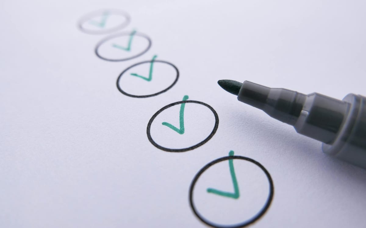 A row of hand-drawn circles each ticked with a green checkmark beside a marker pen — each step of the Hong Kong setup process completed in turn